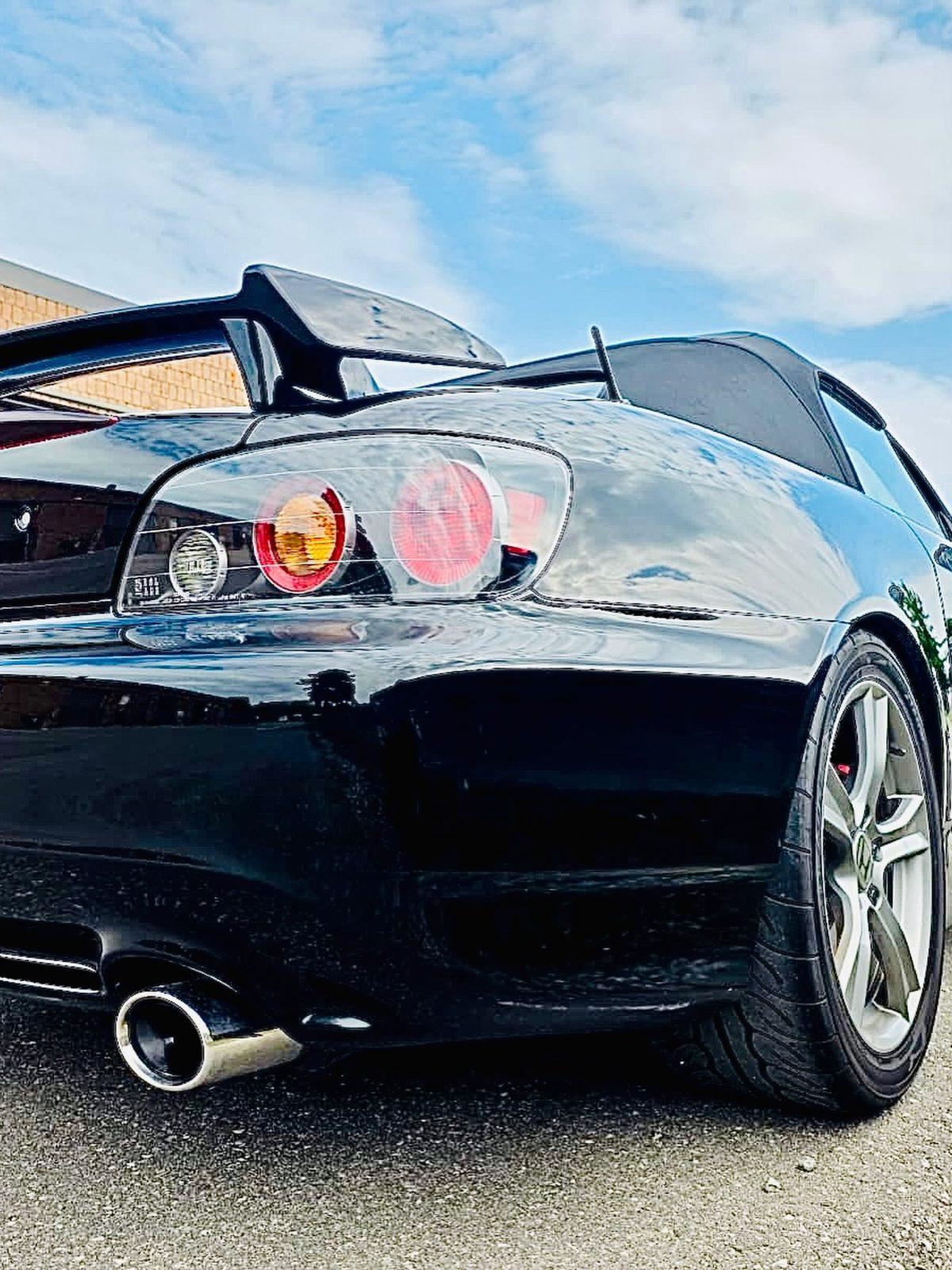 Rear three-quarter view of the black S2000 after ceramic coating